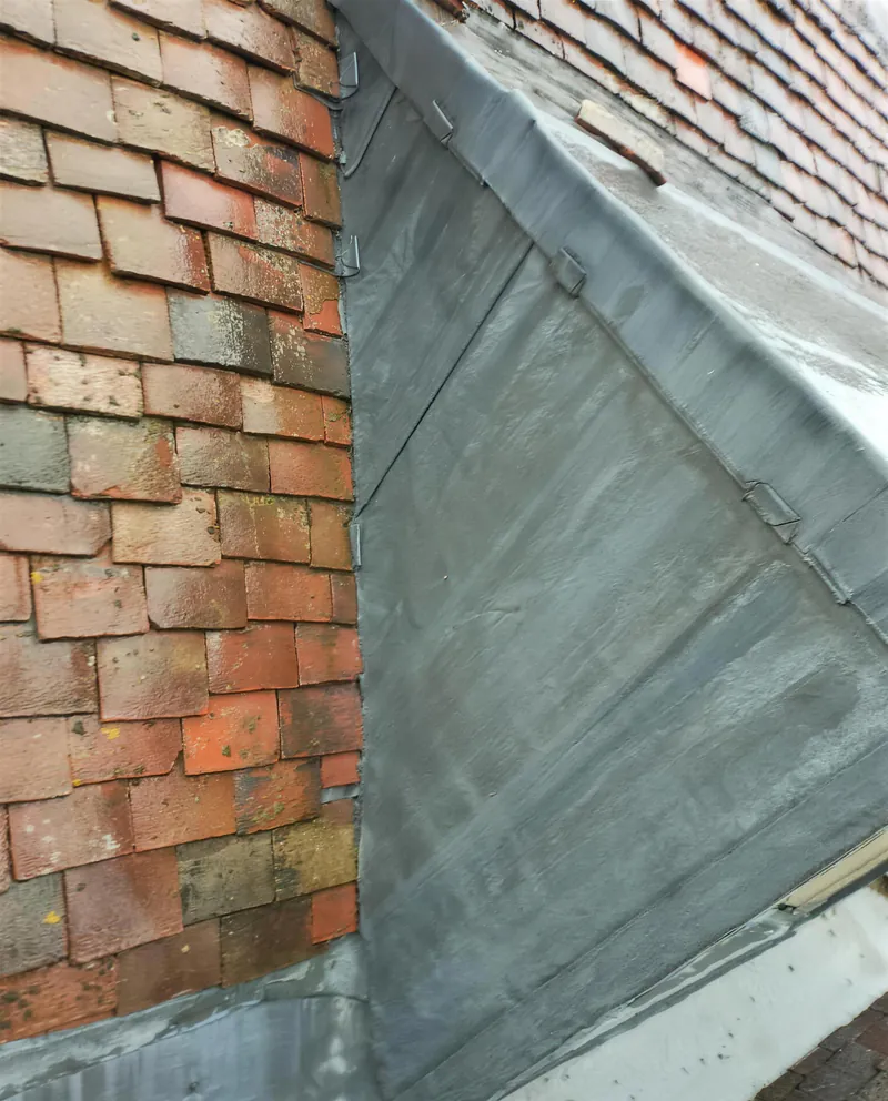 New lead cladding on a dormer cheek in a clay tiled roof