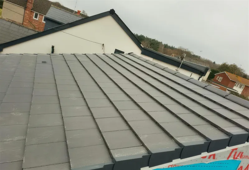 New grey tiled roof on a single storey extension