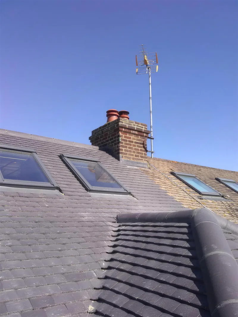 Re-slated roof with three roof windows and a brick chimney stack