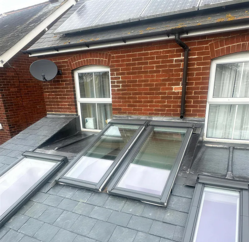 Finished slate roof with four roof windows on a rear extension