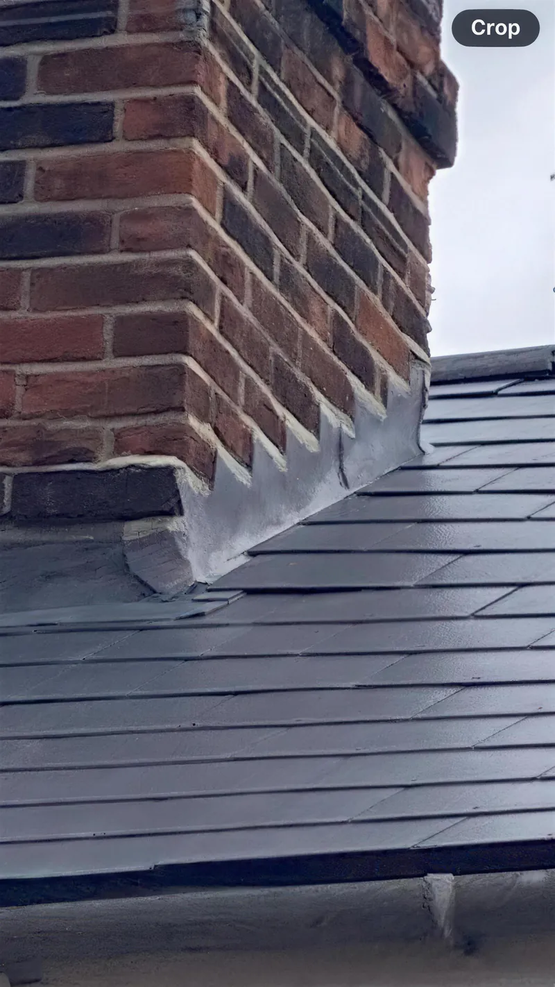 New stepped lead flashing where a brick wall meets a slate roof