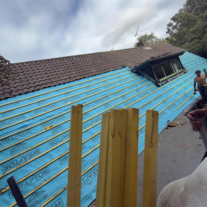 LM Roofing team fitting new battens over breathable membrane on a long roof slope