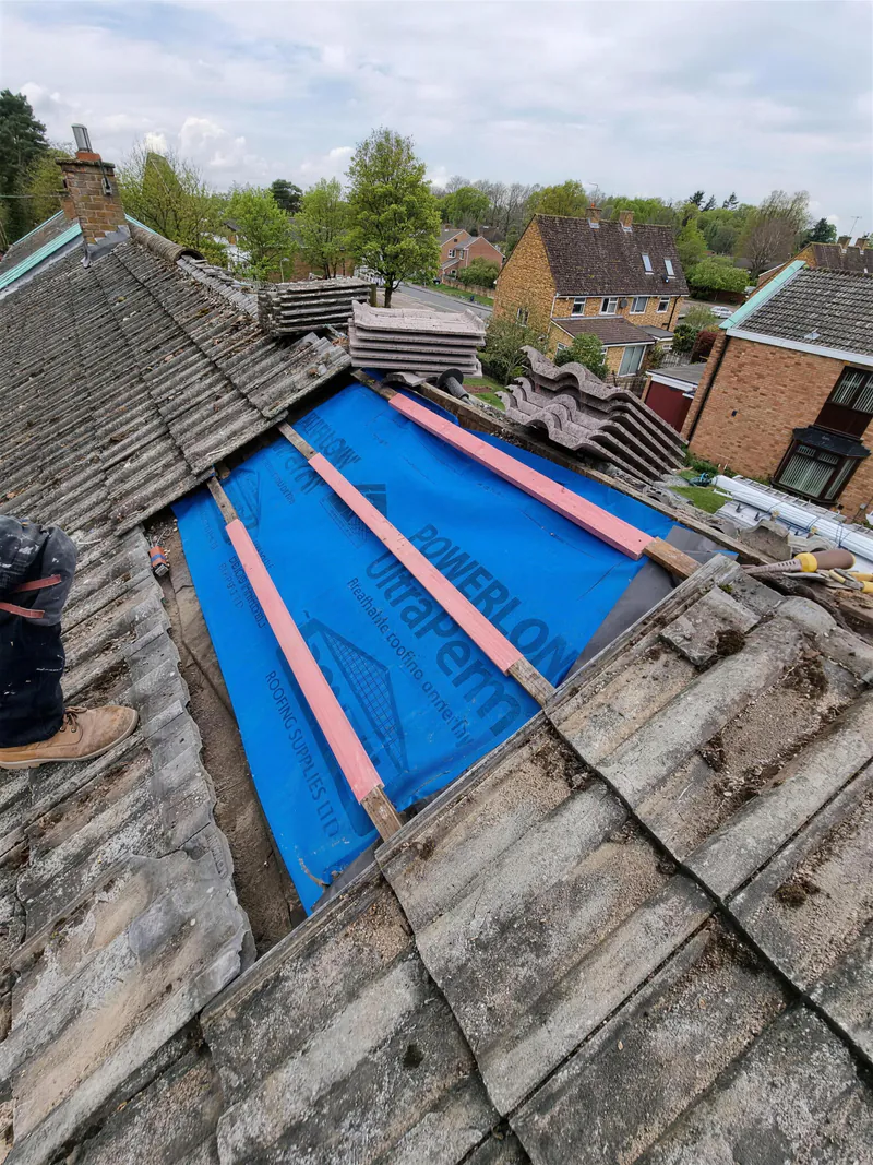 Section of tiled roof stripped to new membrane and battens for a repair